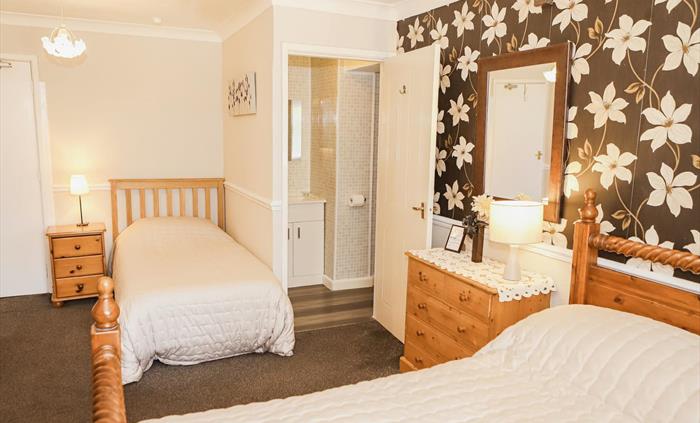 Family bedroom with cot and private facilities